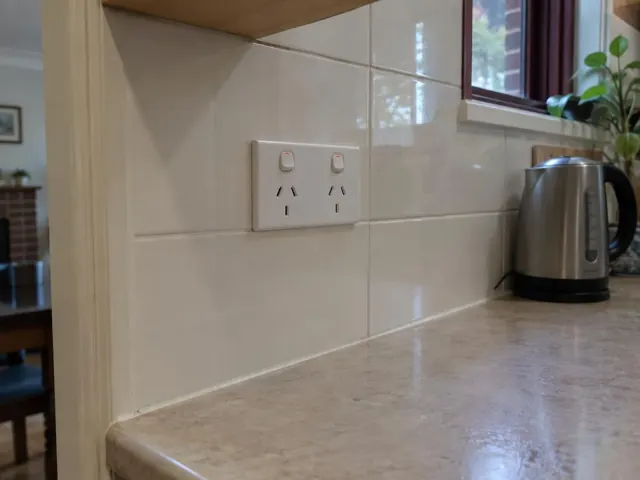Double power point on tiled kitchen splashback above a benchtop in a home kitchen in New Lambton