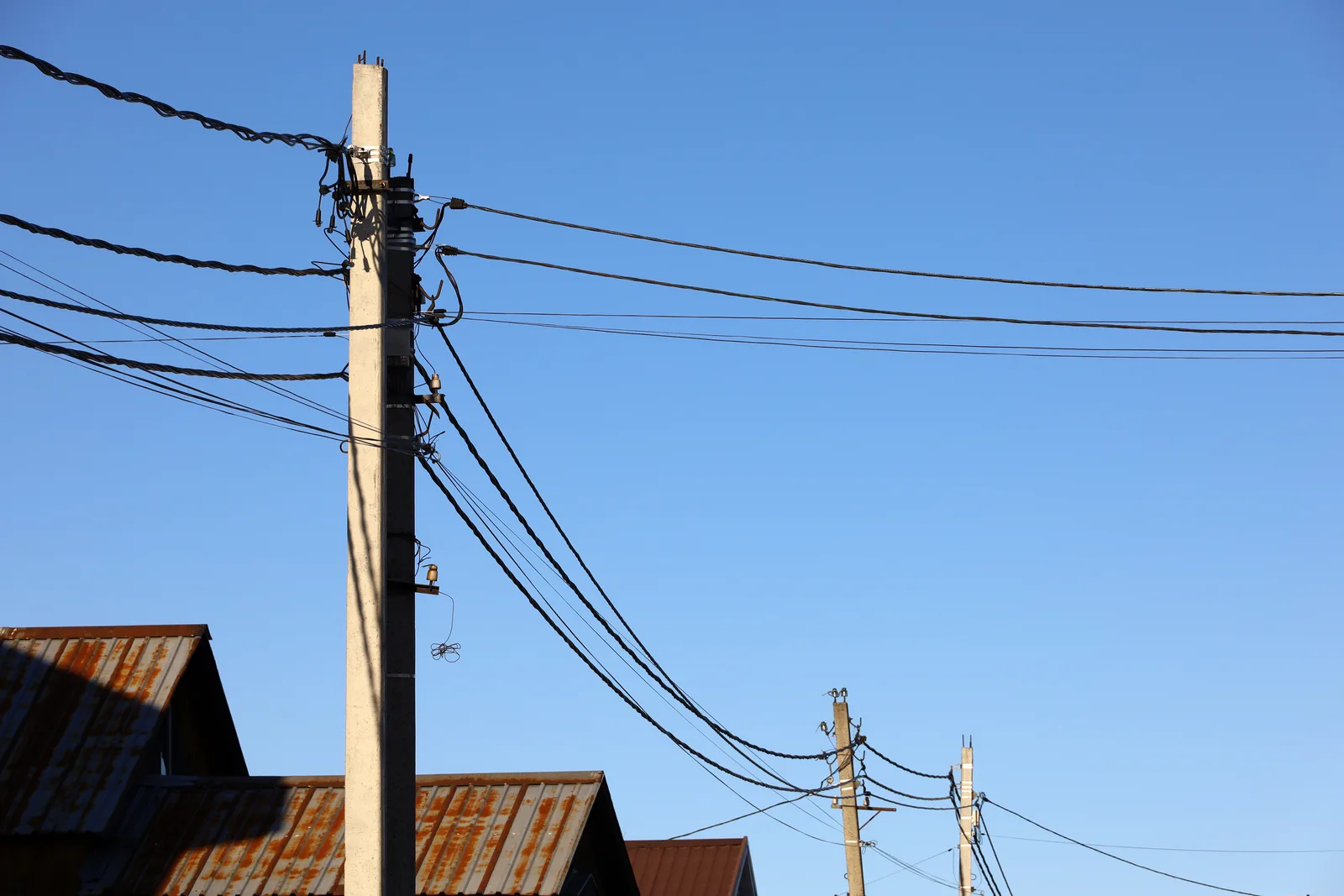 Private power poles carrying overhead service lines