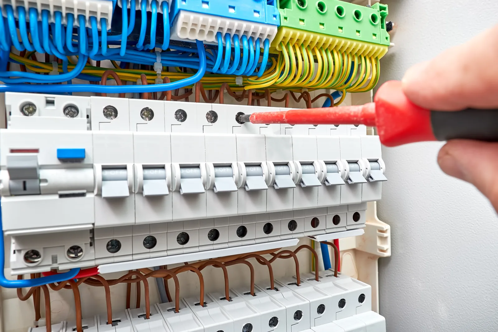 Switchboard circuits being tested with an insulated screwdriver